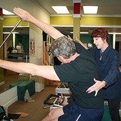 Vicki Hickerson, owner and lead instructor of Body Springs pilates, teaching student on the reformer.