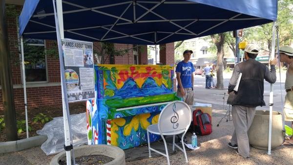 Piano -- in summer '15 -- with canopy for shade, and street performers