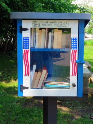 Take A Book, Return A Book box located in seating area in front of the Annapolis Maritime Museum.