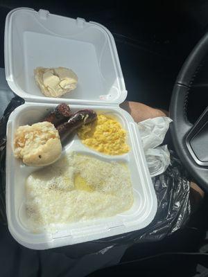 Beef sausage , grits , cheese eggs  and biscuits with apple jelly