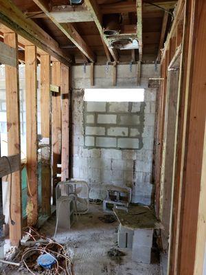 full demo bathroom remodel with blocked in window.