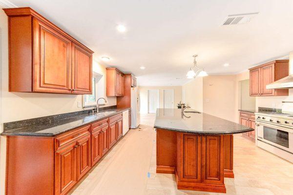 These rich cherry glaze traditional kitchen cabinets adds a classic charm to every home.