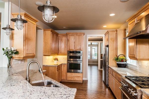 birch cabinetry, stainless appliances, granite counter tops, hardwood flooring, pendant lighting, brushed nickel faucet