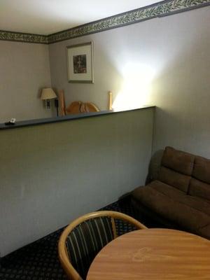 The weird wall between the bed and sitting area.