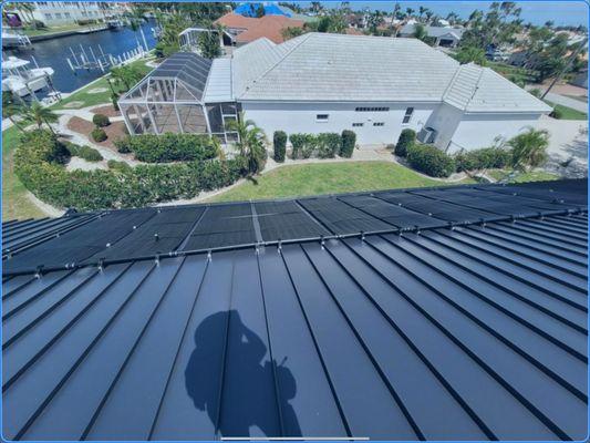 State of the art solar pool heating system on a standing seam roof with NO roof penetrations.