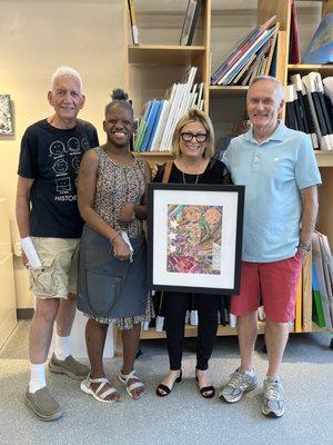 Our friend is holding the lovely portrait created by the artist, who is standing next to her