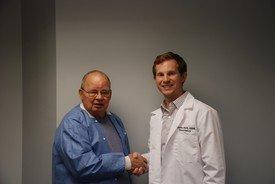 Dr. Solt shaking hands with Dr. Rader