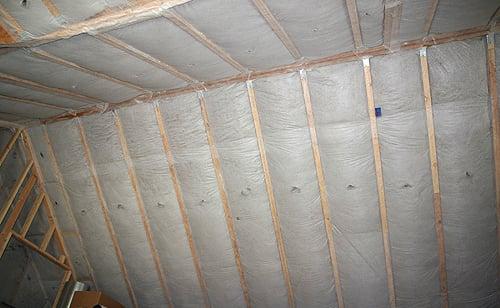 Netted and stapled cellulose insulation in vaulted ceiling.