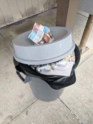 Garbage cans in front by mailboxes