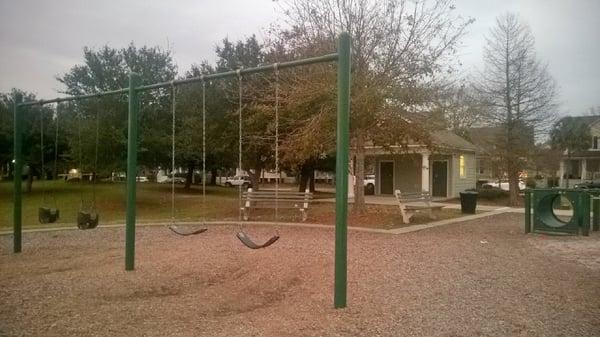 Playground with restrooms in background.