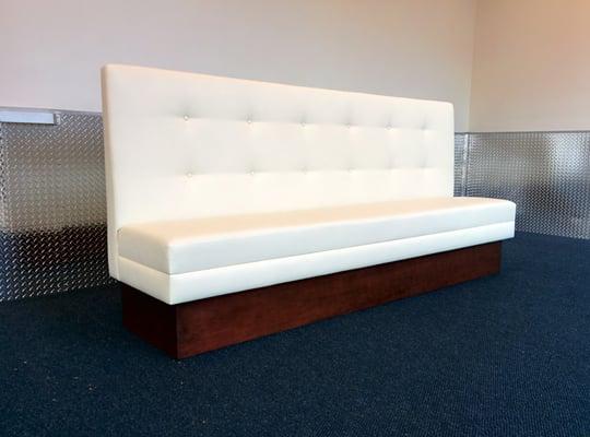 The custom upholstered banquette was constructed along with a finished wooden base.