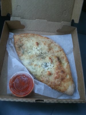 My favorite calzone: ham, black olives, extra spinach.