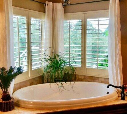 Master Bath 3.5 Louver Plantation Shutter. Center tilt, two panel shutter. Corner window set with garden tub.