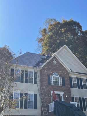 2 story house being roofed.