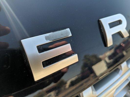 Damaged emblems on hood of Range Rover