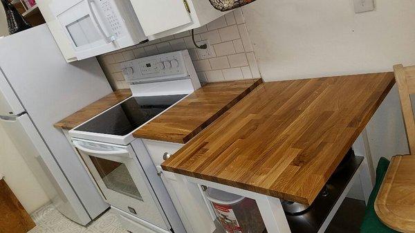 Ripped out old tile countertops and backsplash and replaced with new oiled finished butcher block.