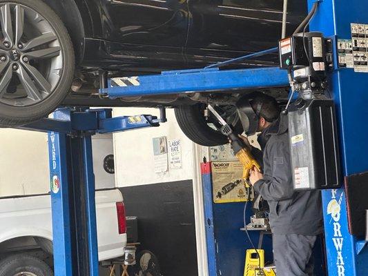 Ramon working on cutting out catalytic converter.