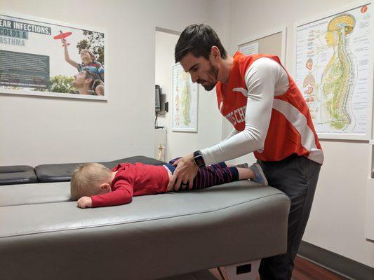 Dr. Logan helping Finn get ready for his afternoon playtime