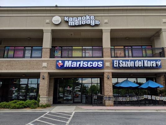 Storefronts for Karaoke Melody II and Mariscos El Sazon del Kora.