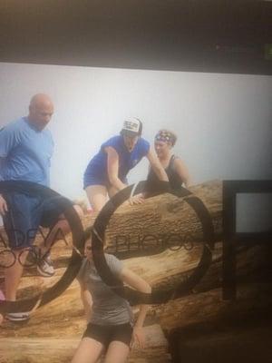 Jennifer Q navigating the log obstacle.