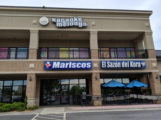 Storefronts for Karaoke Melody II and Mariscos El Sazon del Kora.