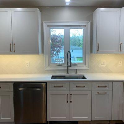 White subway tile on a herringbone layout.