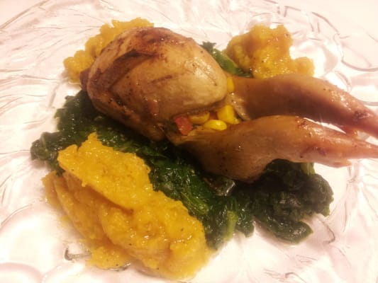 Roasted corn and red bell stuffed quail, with puree of sweet potato and wilted garlic spinach.