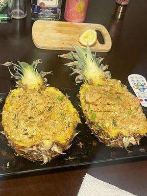 Chicken fried rice inside a pineapple bowl