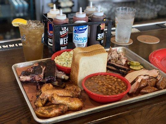 Doc's Sampler / Judging Table: Ribs, Brisket, Pulled Pork, Turkey, Wings, Sausage with side of beans and coleslaw.