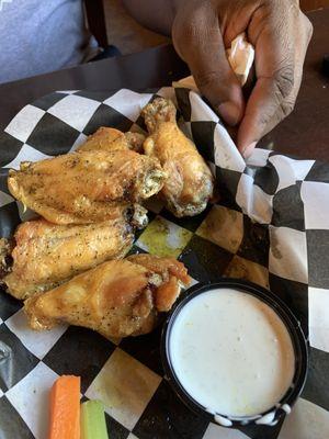 Lemon pepper chicken wings with a side of ranch and veggies as a lunch special and it comes with one side