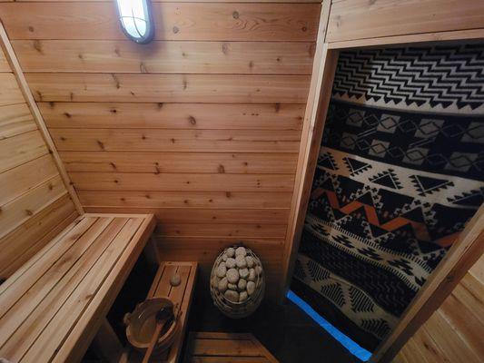 A 4-person Finnish-style sauna that is kept at about 185F.