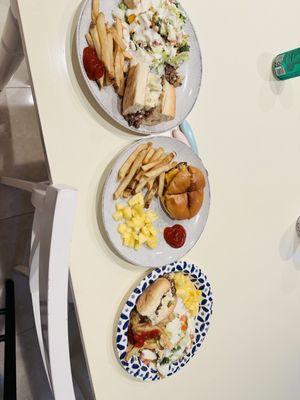 Salad, burger, fries and cheesesteak