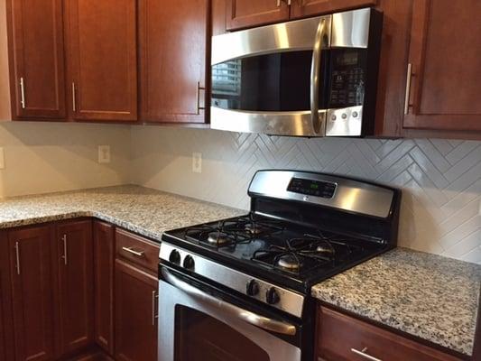 herringbone tile individually cut and placed for kitchen backsplash