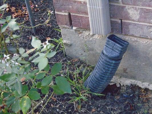 Underground gutter conduit is loose.  Conduit should be replaced to insure proper drainage away from foundation.