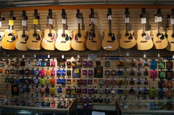 Acoustic guitars, strings, and other accessories.