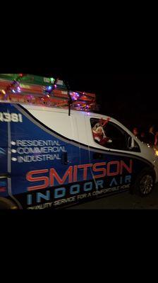 Smitson Indoor Air in the Christmas Parade, my little girl waving to the crowd.