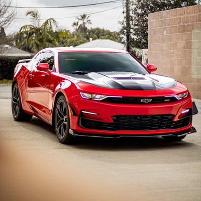 2023 Camaro SS came in for a hood and spoiler wrap in Avery Gloss Black. As well as custom front bumper canards.