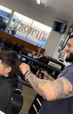 The day my son decided to say goodbye to his mullet and Ruben his barber just having a great time joking around