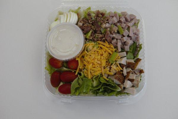 Chef Salad of romaine lettuce, grape tomatoes, turkey, ham, cheddar cheese, eggs and bacon. Ranch Dressing. GF