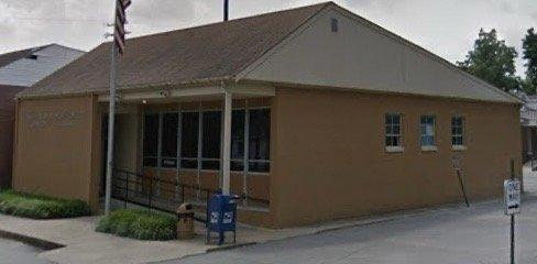 view of front corner of Lepanto, Arkansas post office building and parking lot entrance