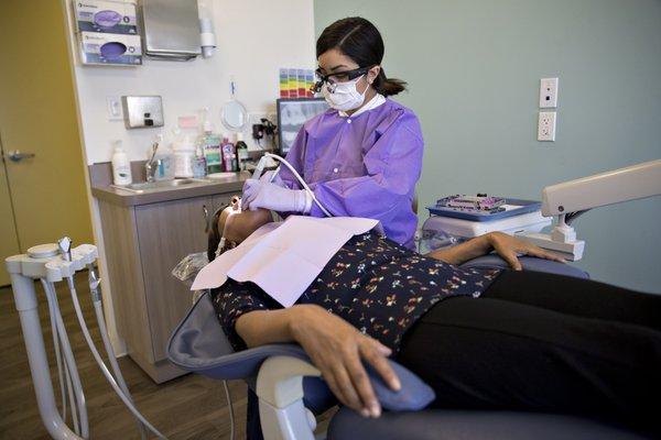 Dental Hygienist doing routine work on a patient