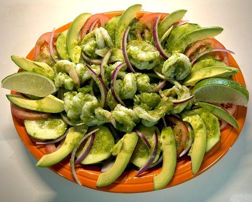 Camarones aguachile: Spicy marinated raw shrimp with lime, chili peppers, garlic, and cilantro. Served with cucumbers, onions, and avocado