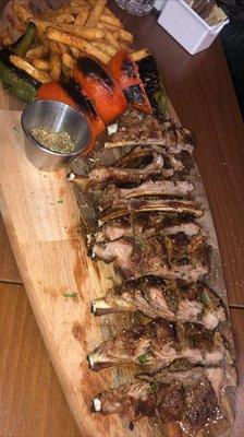 Baby lamb ribs cooked over charcoal wood fire.