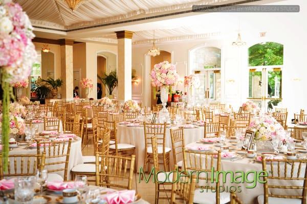 The Patrick Haley Mansion Ballroom is transformed with the help of extravagant floral centerpiece decor provided by Yanni Design Studio.