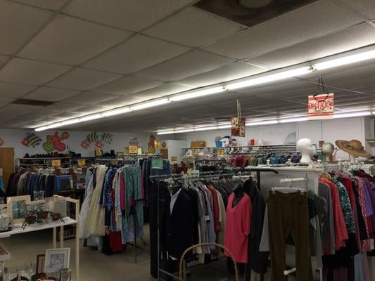 A wide selection of clothing and shoes (on the back wall).