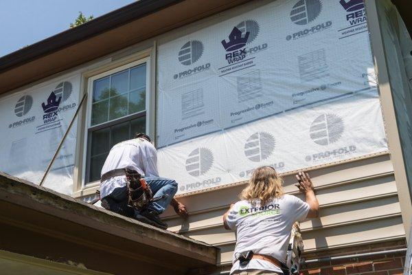 CertainTeed vinyl siding being installed over Pro-Fold underlayment and Rex Wrap barrier protection