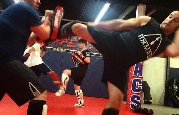 Learning essential Muay Thai Kickboxing techniques in the Combat Striking 101 program.