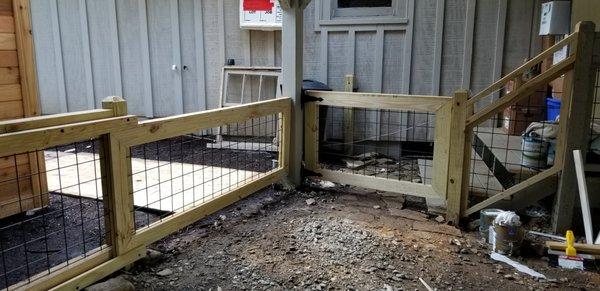 The swinging gate latches on 2 different posts so the homeowner can change how their dogs are contained.