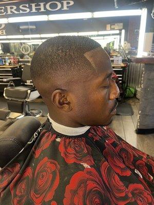 Mid high bald fade with a line up. 1 1/2 on top with the grain