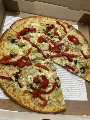 The BEST gluten free cauliflower pizza crust! This is the pesto chicken, artichoke heart and red pepper pizza.